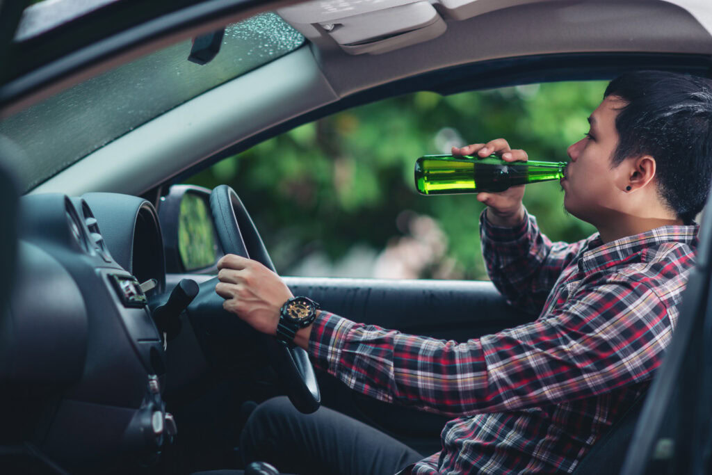 man drinking and driving the car DUI