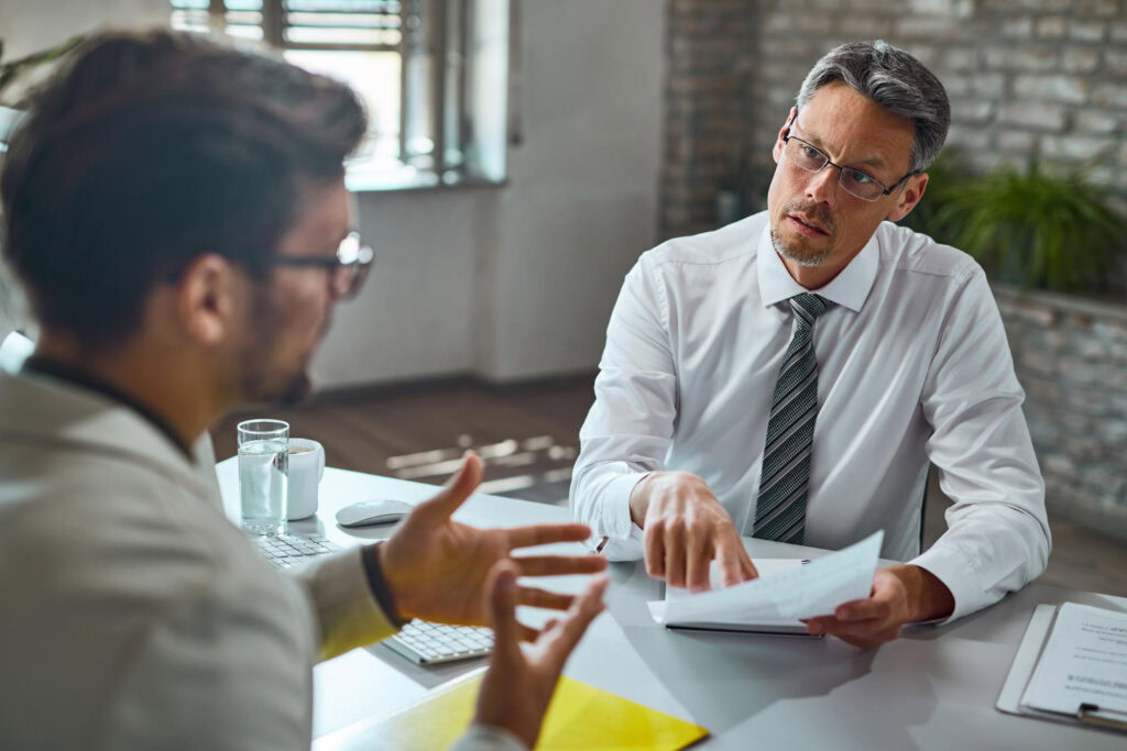 a man in a suit and tie taking interview and checking records-misdemeanors that prevent employment